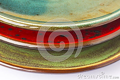 Three ceramic plates of different colors. Part of the frame Stock Photo