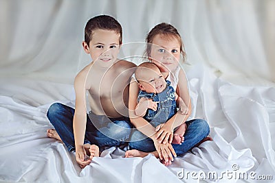 Three cheerful siblings at home Stock Photo