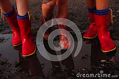 Children after the rain with rubber boots Stock Photo