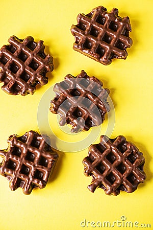 Three chocolate waffles on a yellow background, flat lay, top view Stock Photo