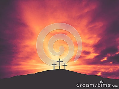 Three Christian Easter Crosses on Hill of Calvary with Colorful Clouds in Sky Stock Photo