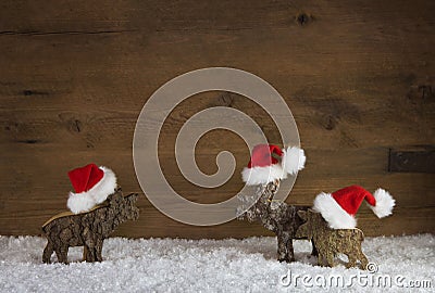 Three christmas reindeer of handmade wood with red white santa h Stock Photo