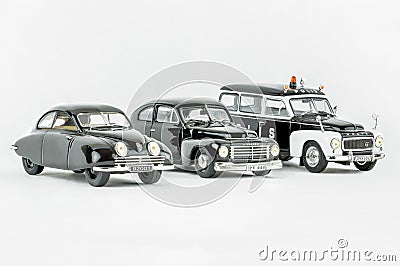 Three classic vintage miniature cars, one police car, Scale models. Editorial Stock Photo