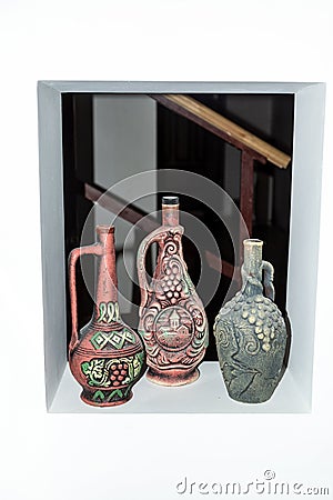 Three clay jars with ornaments in a niche in the wall Stock Photo