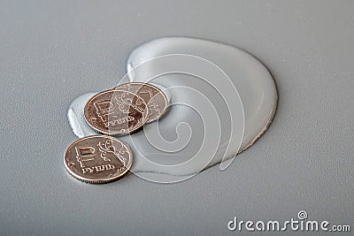 Three coins in the water on a gray surface, Russian rubles Stock Photo