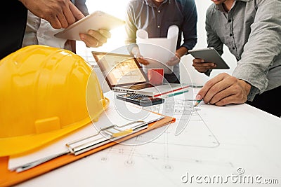 Three colleagues discussing data working and tablet, laptop with on on architectural project Stock Photo