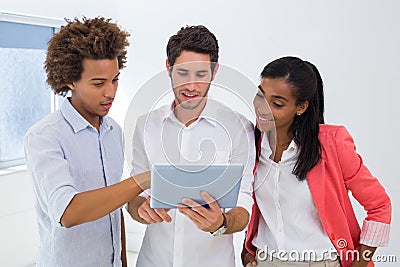 Three colleagues working on tablet pc Stock Photo