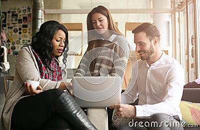 Three colleagues working together on laptop. Close up. Stock Photo