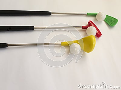 Three colored Golf clubs with balls on white background Stock Photo