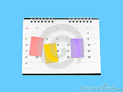 three colorful sticky notes attached on desk calendar isolated on blue Stock Photo