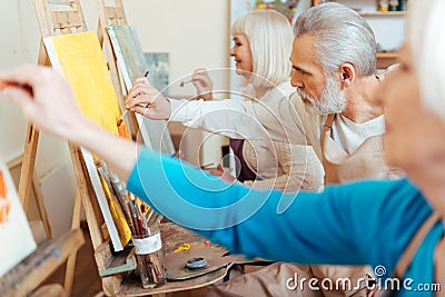 Three concentrated artists spending time in painting studio Stock Photo