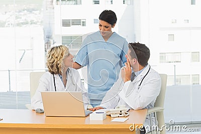Three concentrated doctors in discussion Stock Photo