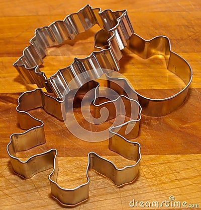 Three cookie cutters on a wooden cutting board Stock Photo