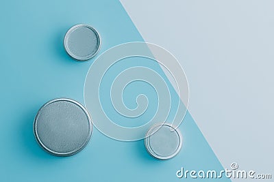 Three cosmetics tins on blue and white background. Copy space. Flat lay. Stock Photo