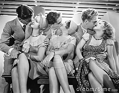 Three couples romancing and kissing Stock Photo