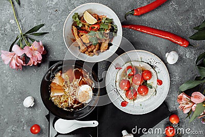 Three-course business lunch. cherry tomatoes with tofu mousse, thai rice with chicken and vegetables, asian noodle soup, ramen Stock Photo