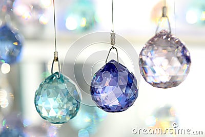 Three crystal ornaments hung on string Stock Photo