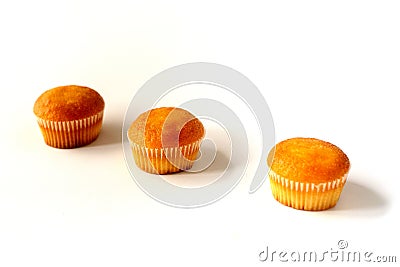 Three cupcakes with different fillings, side view in perspective, on a white background Stock Photo