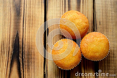 Three cupcakes with different fillings, top view, on wooden background Stock Photo