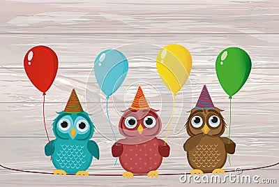 Three cute colored owls sitting on a rope and holding balloons. Stock Photo