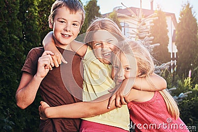 Three cute little friends cuddling and play. Stock Photo
