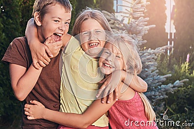 Three cute little friends cuddling and play. Stock Photo