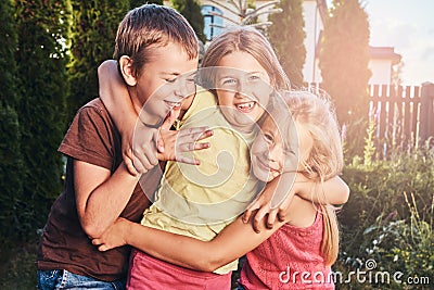 Three cute little friends cuddling and play. Stock Photo