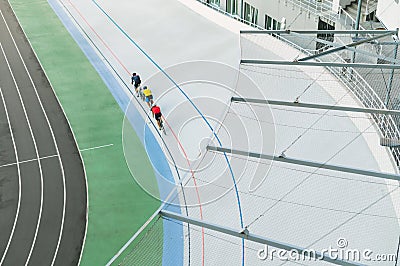 Three cyclists train on the velodrome, top view. Professional cyclists ride on the bike path, top view. Cycling. Track bike. Editorial Stock Photo