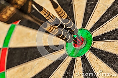 Three darts in bull's eye close up Stock Photo