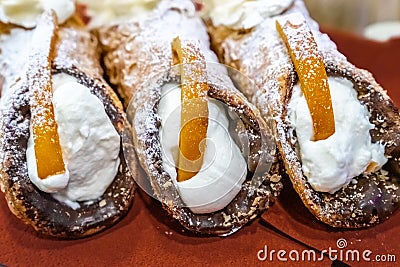 Three delicious sicilian cannoli stuffed with cream cheese Stock Photo