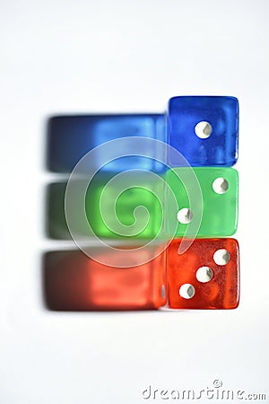 Three dices, one blue, another green and another red. Stock Photo