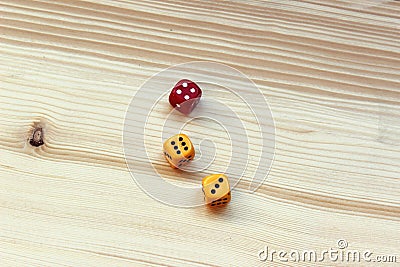 Three dices on wooden background. Stock Photo