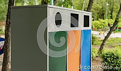 three different colorful metal trash bins or containers, garbage sorting and recycling concepts Stock Photo