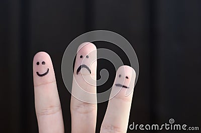 Three different emoticons hand drawn on fingers Stock Photo