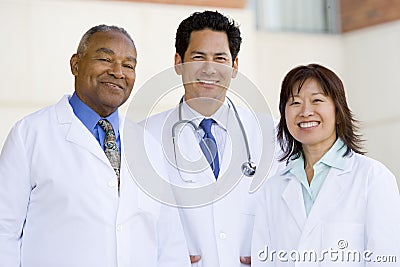 Three Doctors Standing Outside A Hospital Stock Photo