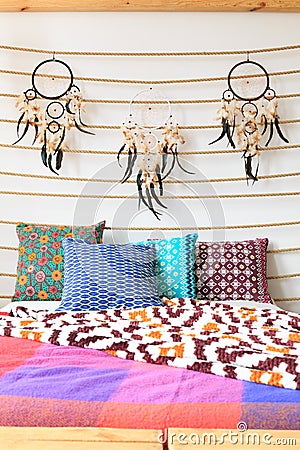 Three dreamcatchers above cushions Stock Photo