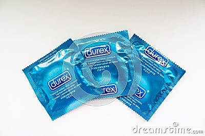 Three Durex condoms in blue packaging on a white background Editorial Stock Photo