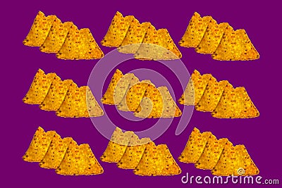 Three each bitten nachos on violet color background Stock Photo