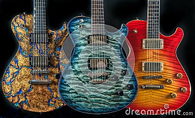 Three Electric Guitars Made of Fancy Figured Wood Colorful Music Stock Photo