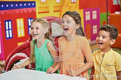 Three emotional kids in playroom. Stock Photo
