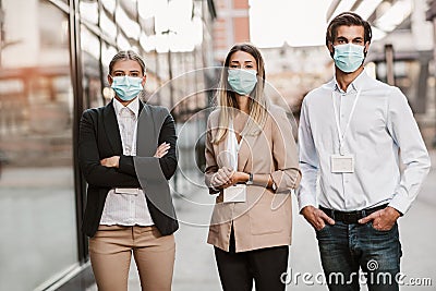 Employers standing outdoor wearing face mask Stock Photo