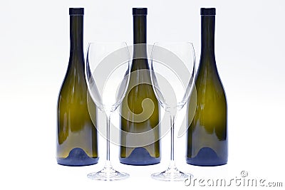 Three empty upturned wine bottles and two glasses on a white background Stock Photo