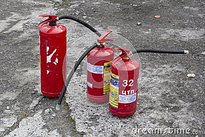 Three fire extinguishers ready for use. Editorial Stock Photo