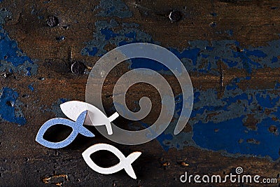 Three fish shapes on an old wooden surface Stock Photo