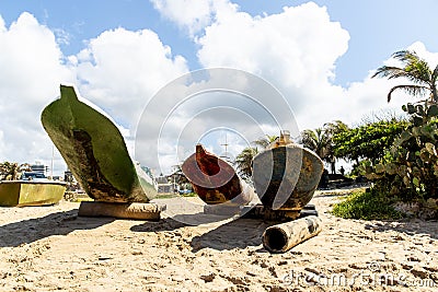 Three fishing canoes docked in the sand on the beach Stock Photo