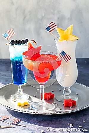 Three fourth of July cocktails garnished with American flags and fresh fruit. Stock Photo