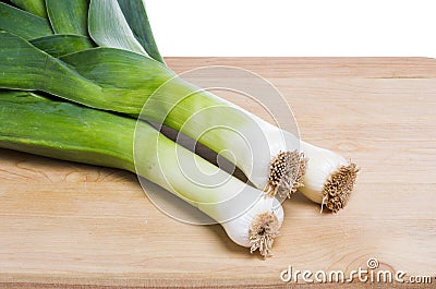 Three fresh leeks on cutting board Stock Photo