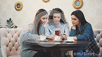 Three Friends Sitting in a Cafe with a Smart Phone and Having a Funny  Conversation. Good Girls with Long Beautiful Black Stock Footage - Video of  cell, drink: 155736188