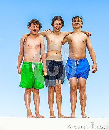 Three friends in swimware stick together Stock Photo