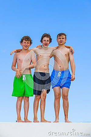 Three friends in swimware stick together Stock Photo